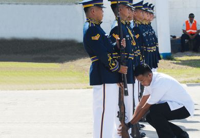 A presidential guard inspects members of the honor guard to illustrate hilippines military training for students ‘aims at stifling dissent’