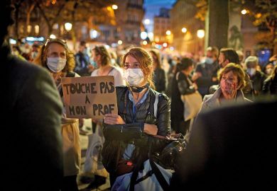 A member of the crowd watching the National Tribute to the murdered school teacher Samuel Paty holds a placard reading 'Do not touch my Professor' at Place de la Sorbonne on October 21, 2020 in Paris, France A member of the crowd watching the National Tribute to the murdered school teacher Samuel Paty holds a placard reading 'Do not touch my Professor' at Place de la Sorbonne on October 21, 2020 in Paris, France.