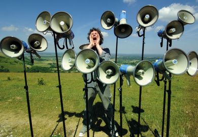Composer and director of The Shout choir surrounded by megaphones on Devils Dyke, Sussex to illustrate Student complaints hit new record levels in England and Wales