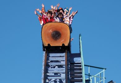 Japanese women ride a roller coaster at Toshimaen amusement park in Tokyo to illustrate Impact of Japanese international tuition fee hike debated