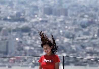 A woman poses for a picture with her hair blown upwards with the Tokyo skyline on the Shibuya Sky observation deck in Tokyo A woman poses for a picture with her hair blown upwards with the Tokyo skyline on the Shibuya Sky observation deck in Tokyo to illustrate ‘Sharp rise’ in science gender quotas at Japanese universities