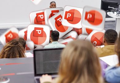 Man lectures students in lecture theatre with Power Point logos falling in front of him to illustrate PowerPoint overuse will be the death of graduate employability