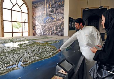 Person shows the architecural model of King Abdullah Economic City in Jeddah Person shows the architecural model of King Abdullah Economic City in Jeddah