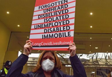 Long covid protester stand outside the Covid-19 Inquiry Hearing Centre to illustrate Study highlights academia’s ‘exhaustion economy’