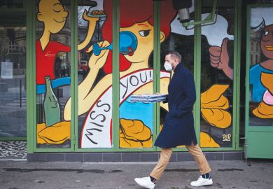 Image of a man swalking past a closed restaurant with a miss you illustration on the shop window