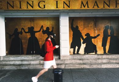 Broadway theaters stand closed along an empty street in the theater district 