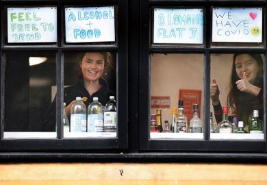 Students look out of the windows of the student accommodation who have been placed under covid-19 restrictions