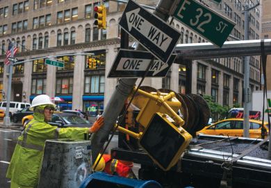 A private contractor helps remove a traffic signpost as a metaphor for Nottingham rapped for ‘misleading’ students over China campus