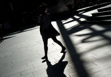 A shadow of a lady casts on the ground in Sydney to illustrate Covid exodus failed to stem sexual abuse on Australian campuses