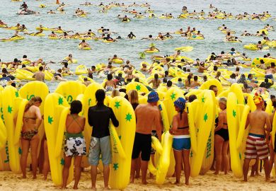 Beachgoers ride on inflatables with some waiting to go into the sea in Sydney, Australia to illustrate Two-step grant applications ‘will transform’ Australian research