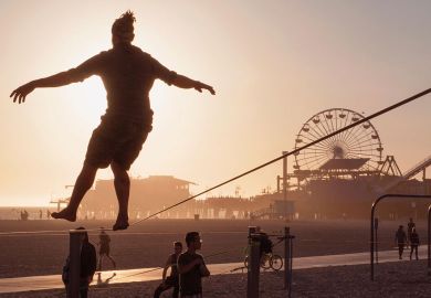 Tight rope practice on beach near the Santa Monica Pier, Los Angeles to illustrate UC plan to hire undocumented students ‘cautiously progressing’