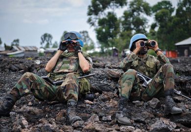 Uruguayan United Nations peacekeepers look through binoculars to illustrate New rules of engagement