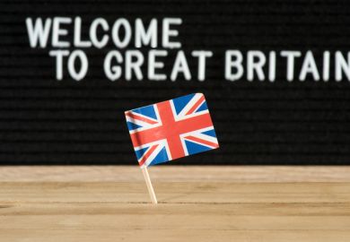 A flag with a sign behind it saying 'Welcome to Great Britain'
