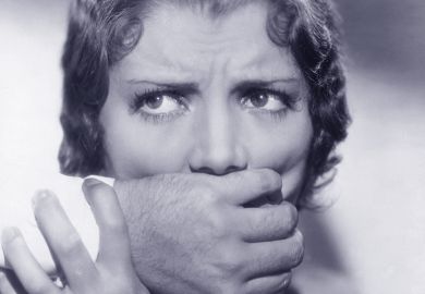 Woman being silenced by hand