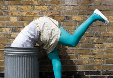 Woman diving into dustbin on street Woman diving into dustbin on street