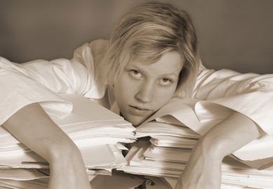 Woman exhausted on papers