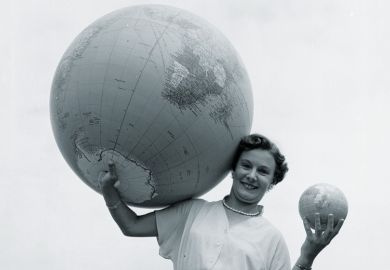 Woman holding large and small globes Woman holding large and small globes