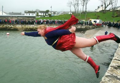woman in superhero costume jumps into harbour