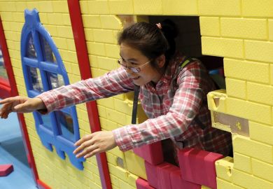 Woman playing with son at indoor playground, Beijing, China, 2015