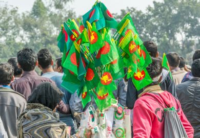 woman buying national flag of Bangladesh to celebration of Bangladesh Independence and National Day at Madhupur, Tangail