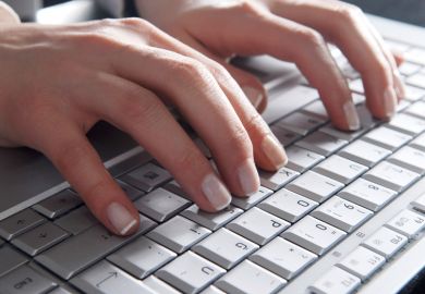 Woman's hands typing on laptop computer keyboard