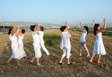 Women dancing in field celebrating Spring Harvest