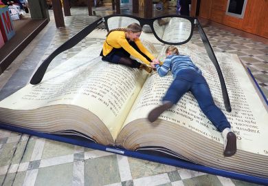 Women lying on giant book