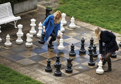 Women play chess on giant outdoor chessboard, Lausanne, Switzerland Women play chess on giant outdoor chessboard, Lausanne, Switzerland