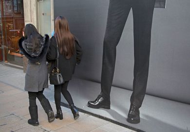 Women walking past mans legs