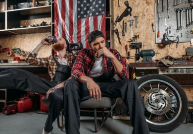Depressed mechanics in the US, in front of an American flag