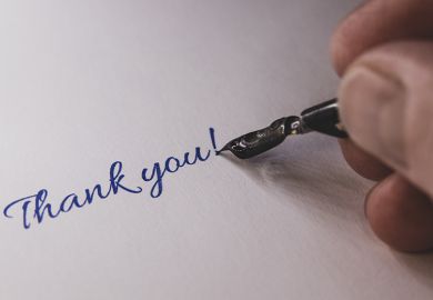 Close-up of a hand from a person writing thank you with a fountain pen
