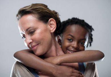 Young girl holding on to woman's back Young girl holding on to woman's back