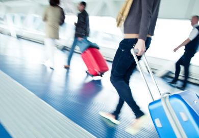 Young male student walking to airport departure lounge Young male student walking to airport departure lounge