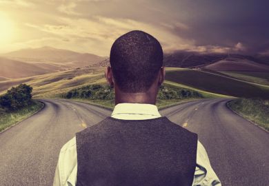 Young man standing at crossroads Young man standing at crossroads