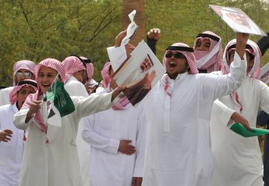 Young Saudi men cheering and celebrating