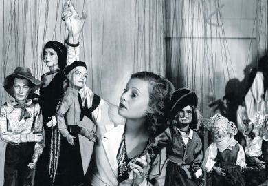 Young woman playing with puppets