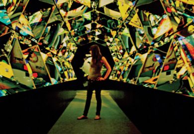 Young woman standing in hall of mirrors