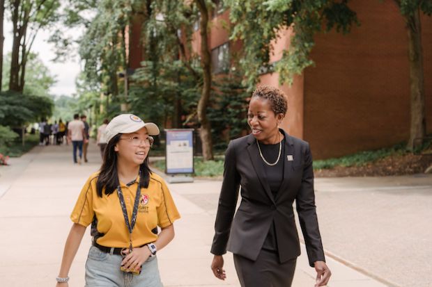 Valerie Sheares Ashby, president of the University of Maryland, Baltimore County, walks with a student on campus