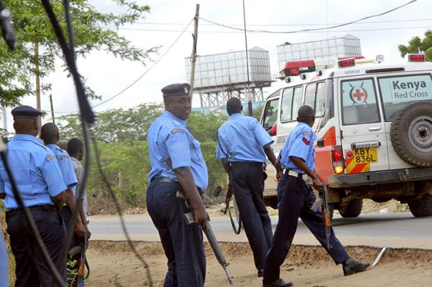 Kenyan police officers take positions outside Garissa University College