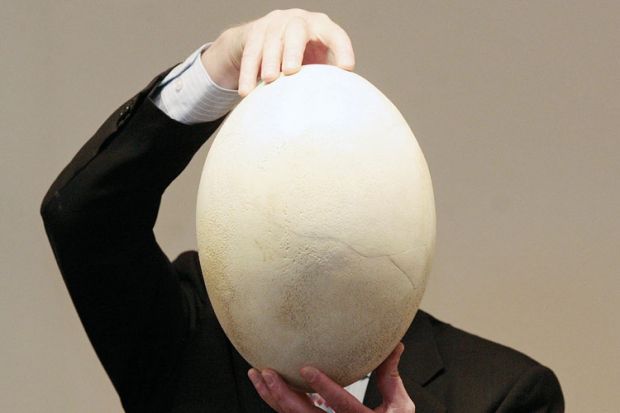 A man holding a large egg