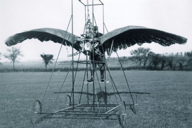 A man inside a winged contraption A man inside a winged contraption