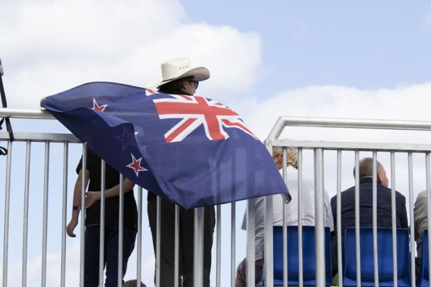 A happy Australian male with the Australian Flag, happy that his Team won the 2021 Catamaran Sail GP event held in denmark for the first time in Scandinavia
