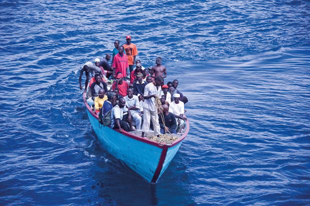 African people in overpacked boat