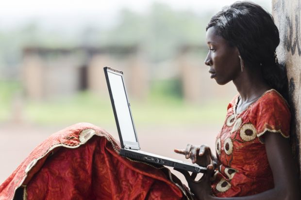 An African woman studies on her computer