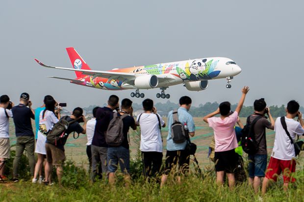 Spectators take photos of Sichuan Airlines’ panda-themed Airbus A350-900 upon its arrival at Chengdu Shuangliu International Airport, China. To illustrate whether the sky is the limit for Asian international student recruitment. Spectators take photos of Sichuan Airlines’ panda-themed Airbus A350-900 upon its arrival at Chengdu Shuangliu International Airport, China. To illustrate whether the sky is the limit for Asian international student recruitment.
