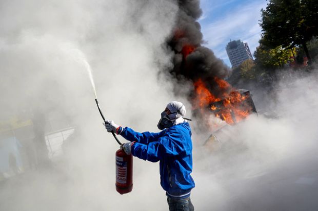 A protester sprays a fire extinguisher during an anti-government demonstration in central Tirana on October 15, 2026, A protester sprays a fire extinguisher during an anti-government demonstration in central Tirana on October 15, 2026,