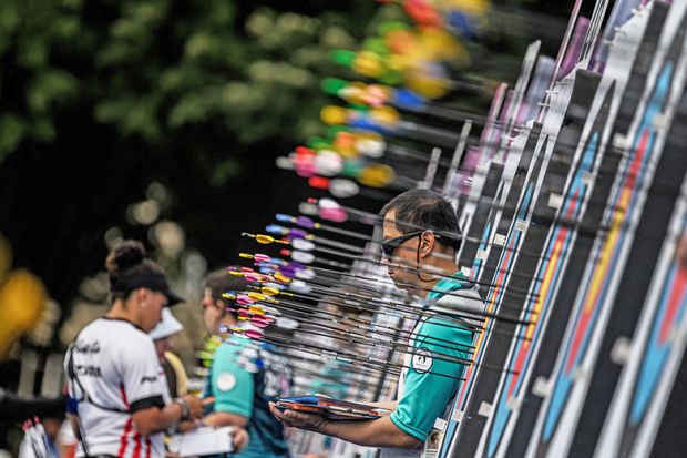 A person looks to be surrounded by arrows as he waits near the targets during an archery competition. To illustrate 'unfair' research income targets for Liverpool’s new academics. A person looks to be surrounded by arrows as he waits near the targets during an archery competition. To illustrate 'unfair' research income targets for Liverpool’s new academics.