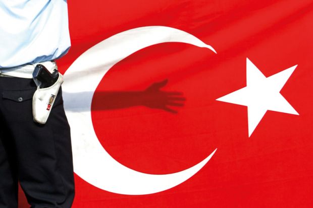 Armed guard standing in front of flag of Turkey
