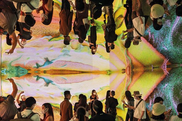 People visit immersive art installation “Machine Hallucinations Space: Metaverse by Refik Anadol at the Digital Art Fair Asia in Hong Kong, 2021