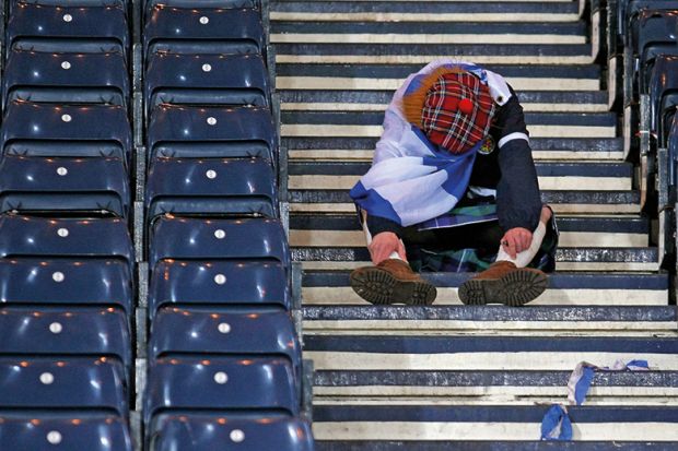 A Scot sitting down on some steps